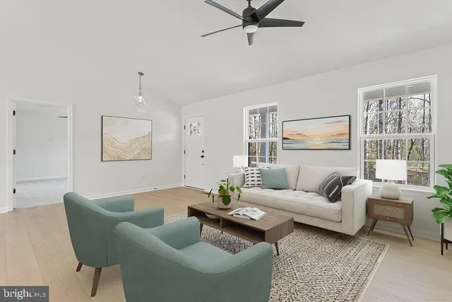 a large kitchen with white cabinets stainless steel appliances and a chandelier