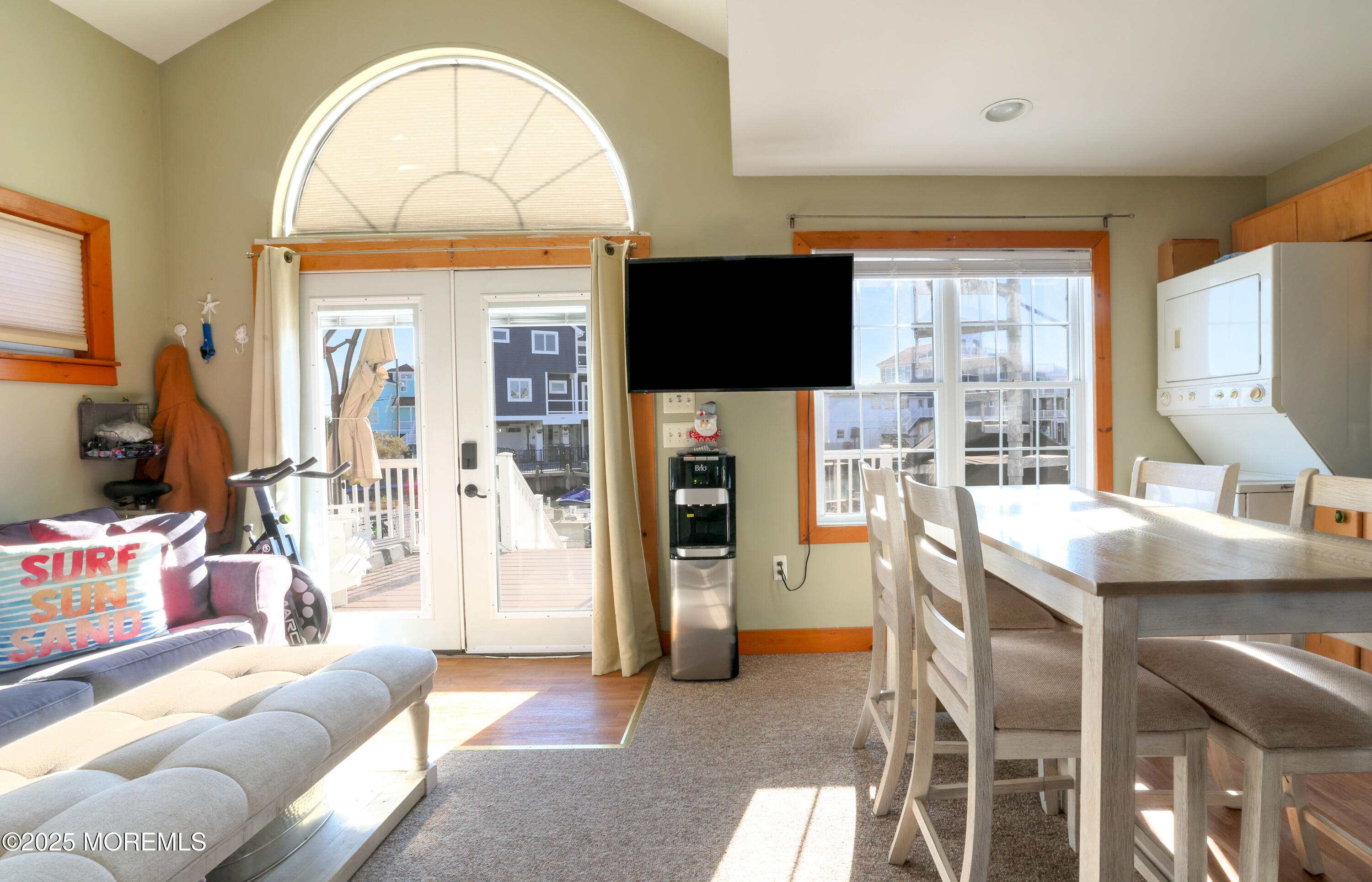 25 B Carroll Avenue Tuckerton, NJ 08087 - Photo 6 of 27 a living room with furniture a flat screen tv and a floor to ceiling window