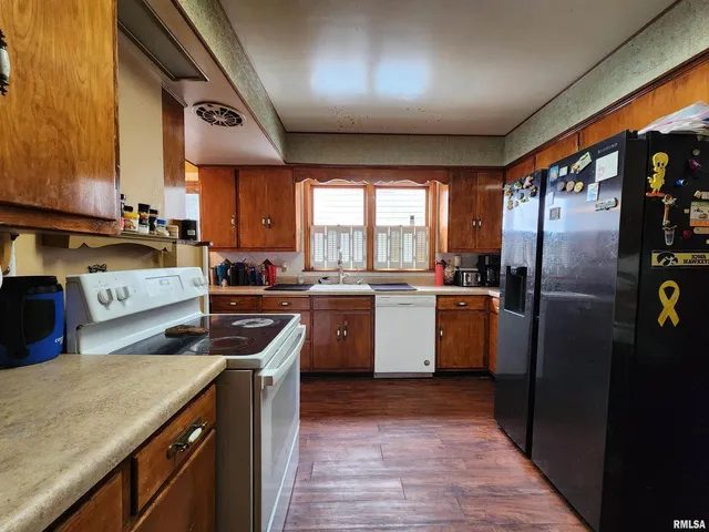 a kitchen with a sink stove and refrigerator