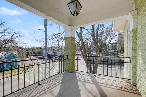 a view of balcony with wooden floor and fence