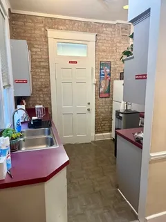 a kitchen with a refrigerator and a stove top oven