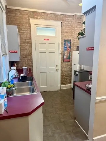 a kitchen with a refrigerator and a stove top oven