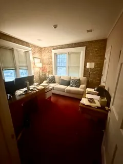 a living room with furniture and large windows