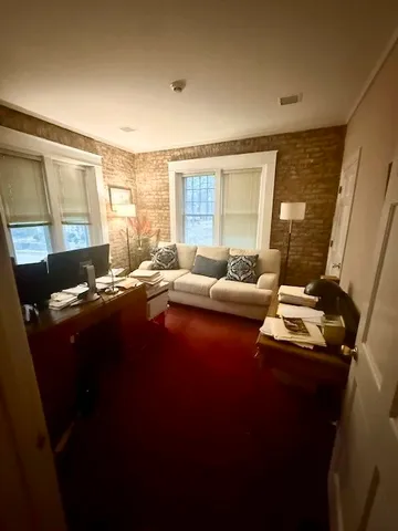 a living room with furniture and large windows