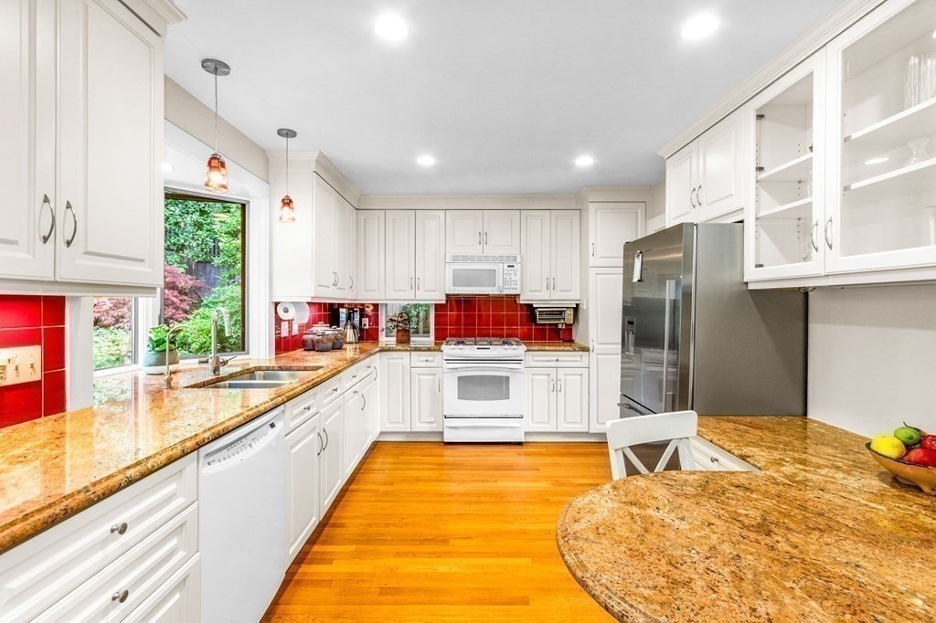 27 Whitney Road Newton, MA 02460 - Photo 13 of 32 a large kitchen with stainless steel appliances kitchen island granite countertop a refrigerator and a sink