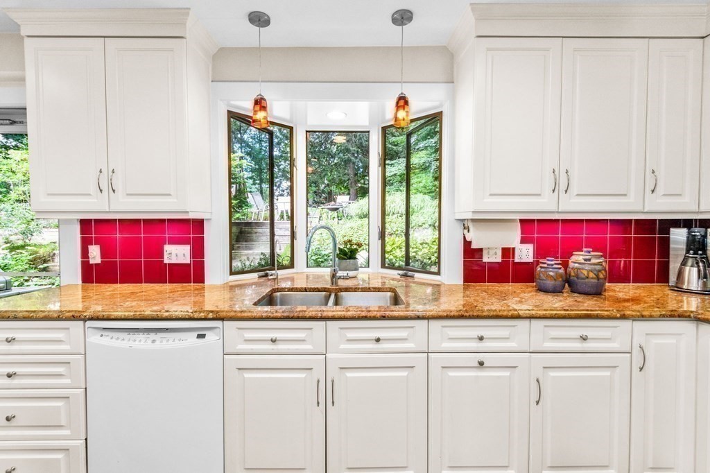 27 Whitney Road Newton, MA 02460 - Photo 14 of 32 a kitchen with stainless steel appliances granite countertop a stove a sink and a microwave