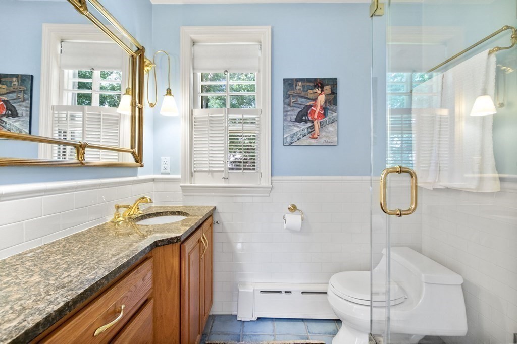 27 Whitney Road Newton, MA 02460 - Photo 18 of 32 a bathroom with a granite countertop sink a toilet and a shower