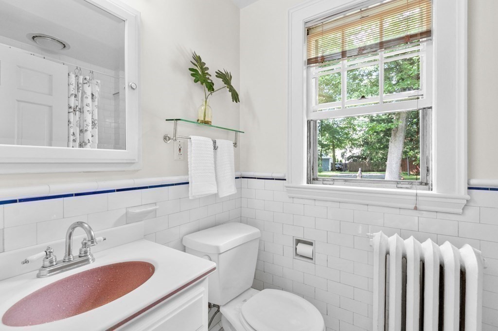 27 Whitney Road Newton, MA 02460 - Photo 23 of 32 a bathroom with a toilet sink and mirror