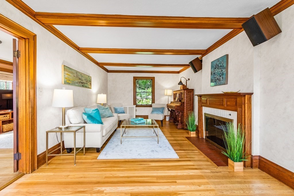 27 Whitney Road Newton, MA 02460 - Photo 5 of 32 a living room with furniture a fireplace and a flat screen tv