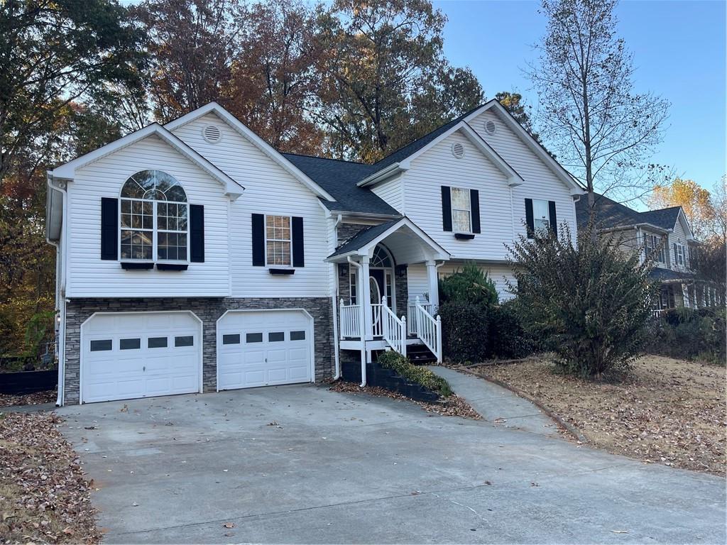 a view of a house with a yard and garage