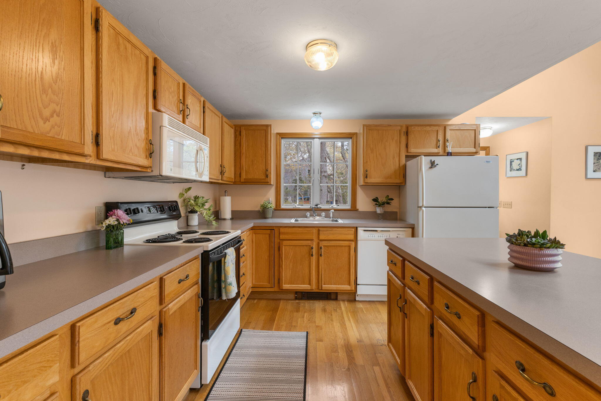 285 Blue Heron Road Wellfleet, MA 02667 - Photo 4 of 31 a kitchen with stainless steel appliances granite countertop a refrigerator sink stove and cabinets