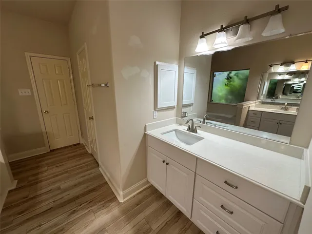 a bathroom with a double vanity sink and mirror