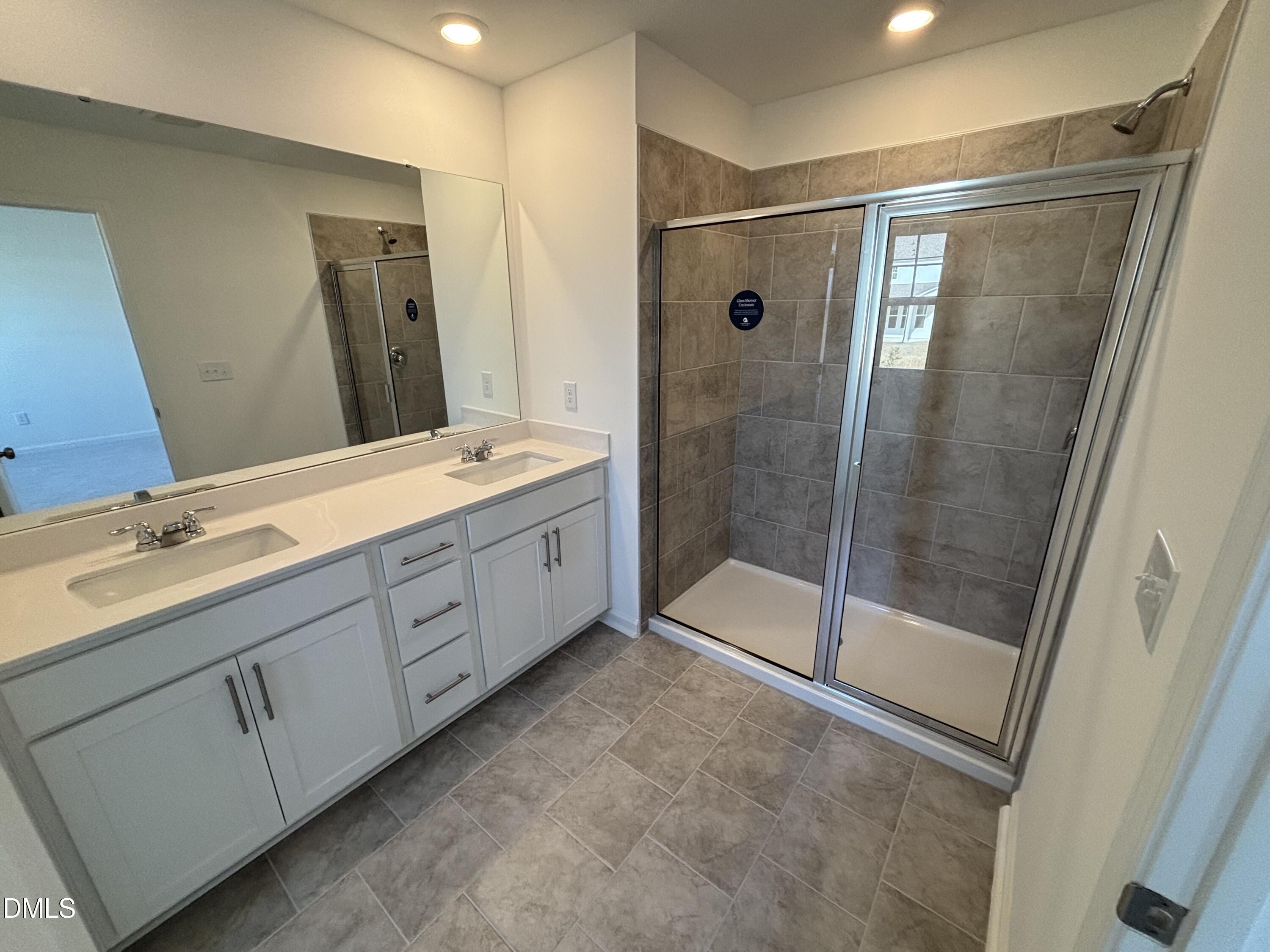 162 Blossom Fld Way Angier, NC 27501 - Photo 21 of 45 a bathroom with a double vanity sink mirror and shower