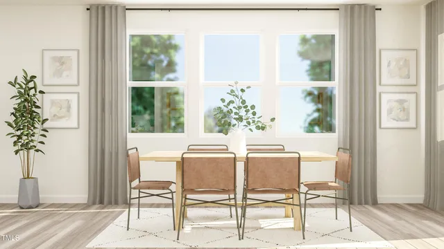 a view of a dining room with furniture and a window