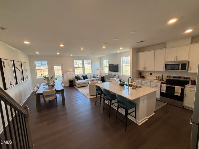 a kitchen with counter space dining table and chairs