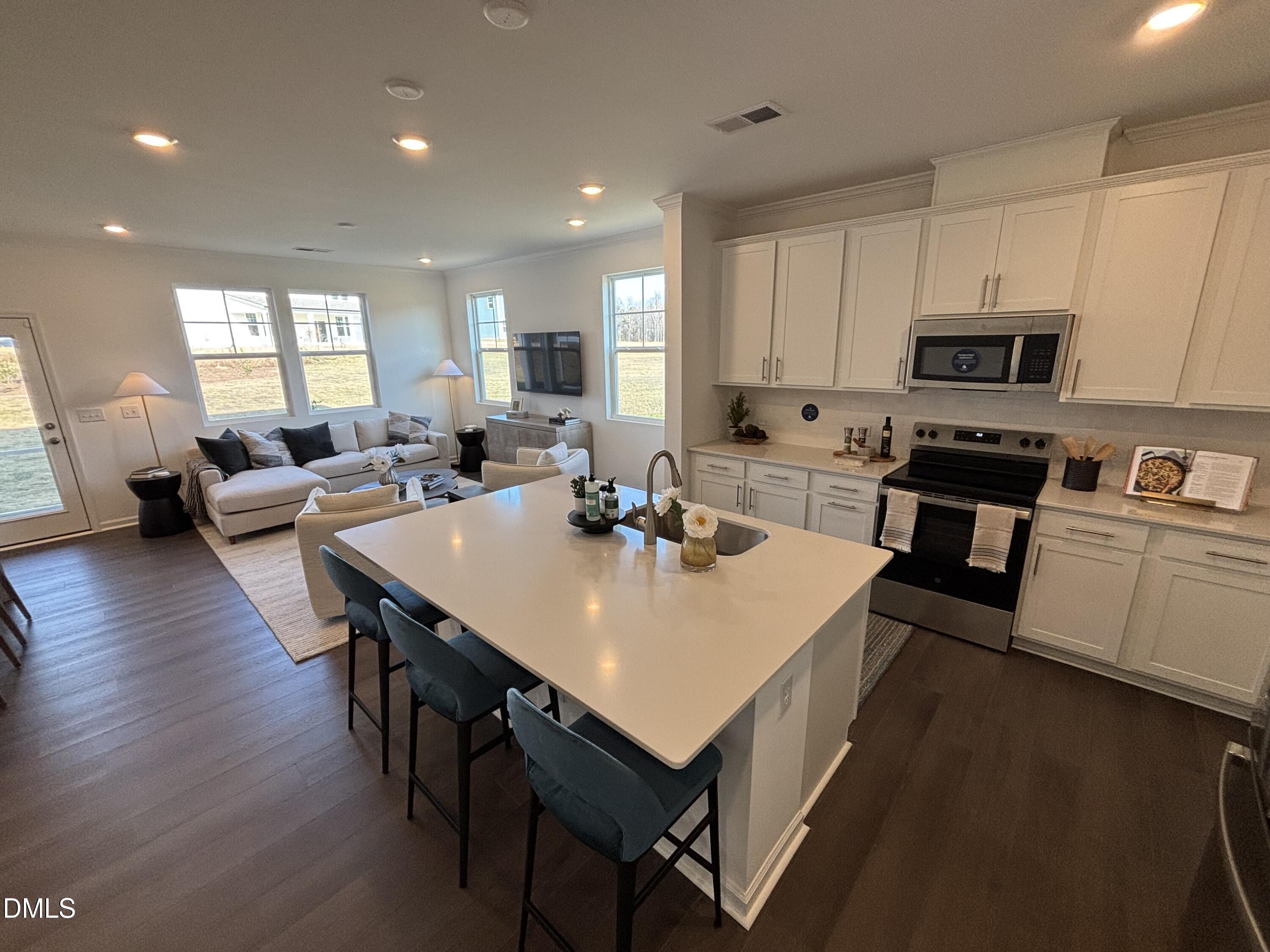 162 Blossom Fld Way Angier, NC 27501 - Photo 5 of 45 a large kitchen with sink a microwave a stove and refrigerator