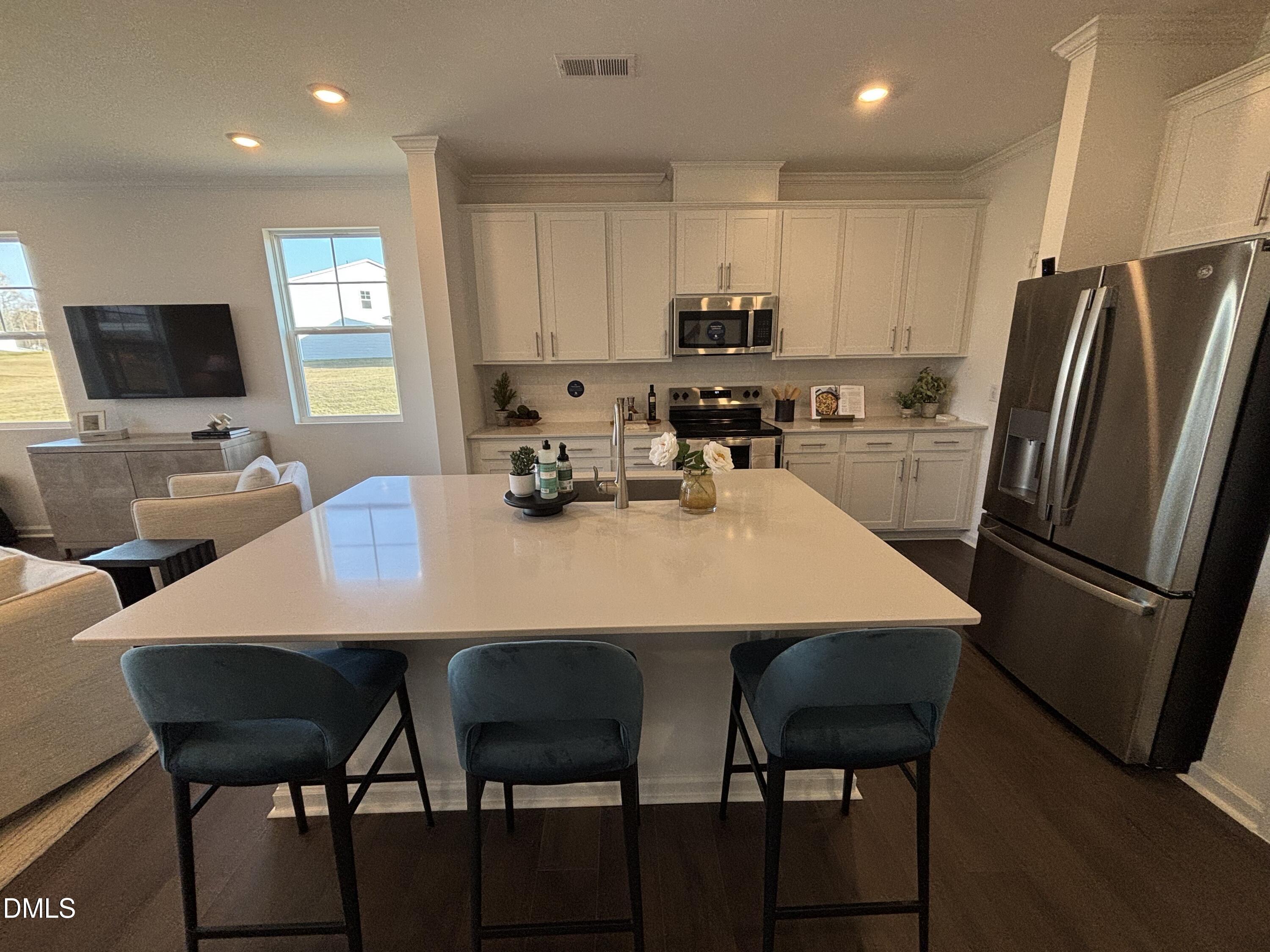 162 Blossom Fld Way Angier, NC 27501 - Photo 6 of 45 a kitchen with a dining table chairs and refrigerator