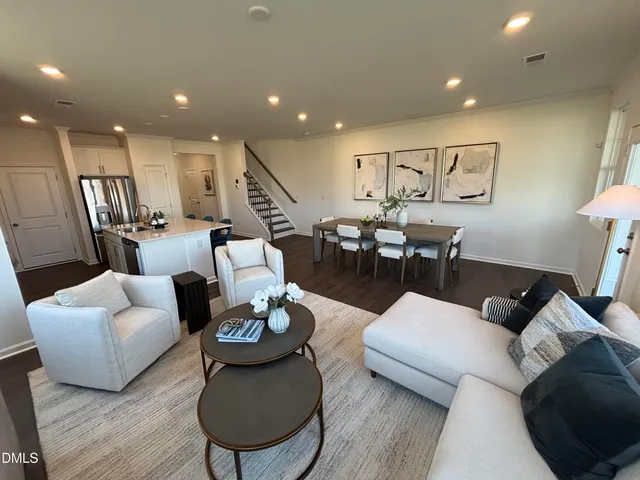 a living room with furniture flat screen tv and a large window