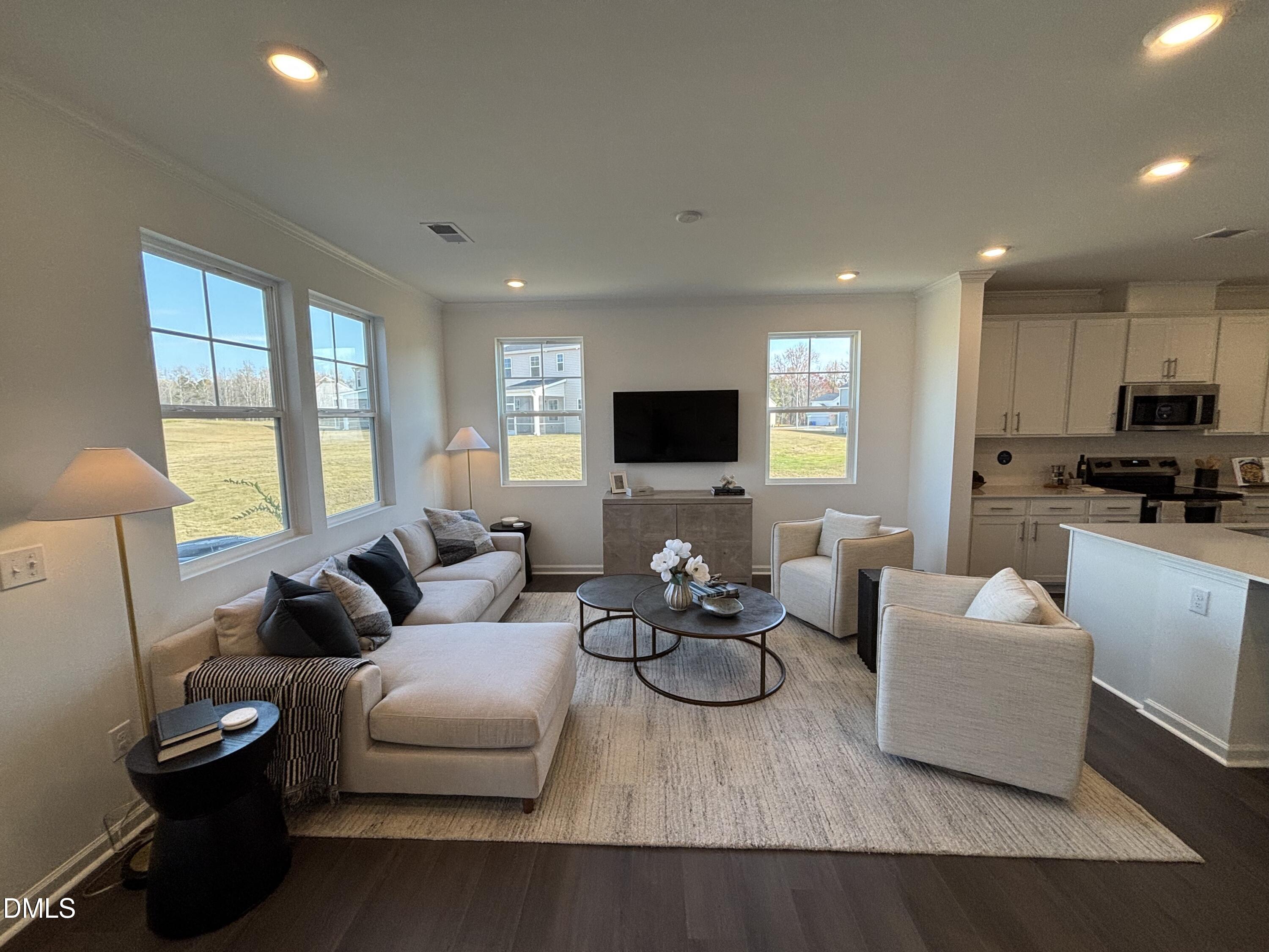 162 Blossom Fld Way Angier, NC 27501 - Photo 10 of 45 a living room with furniture flat screen tv and a large window