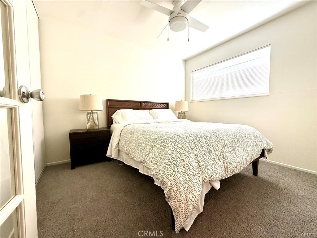 14901 Waverly Lane Irvine, CA 92604 - Photo 12 of 13 a bedroom with a bed and a chandelier