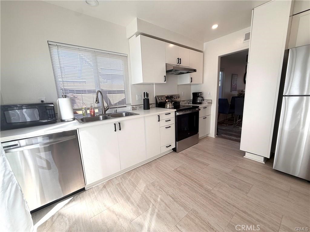 14901 Waverly Lane Irvine, CA 92604 - Photo 4 of 13 a kitchen with a sink stove and refrigerator