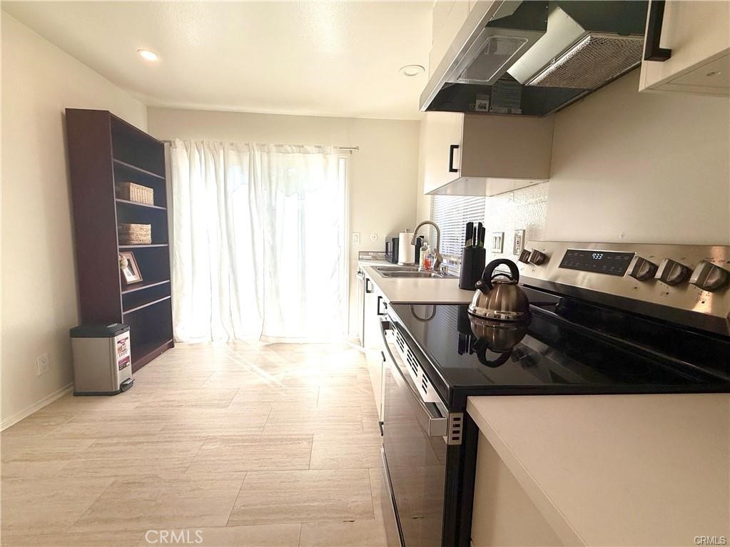 14901 Waverly Lane Irvine, CA 92604 - Photo 5 of 13 a kitchen with stainless steel appliances granite countertop a sink a stove and a refrigerator