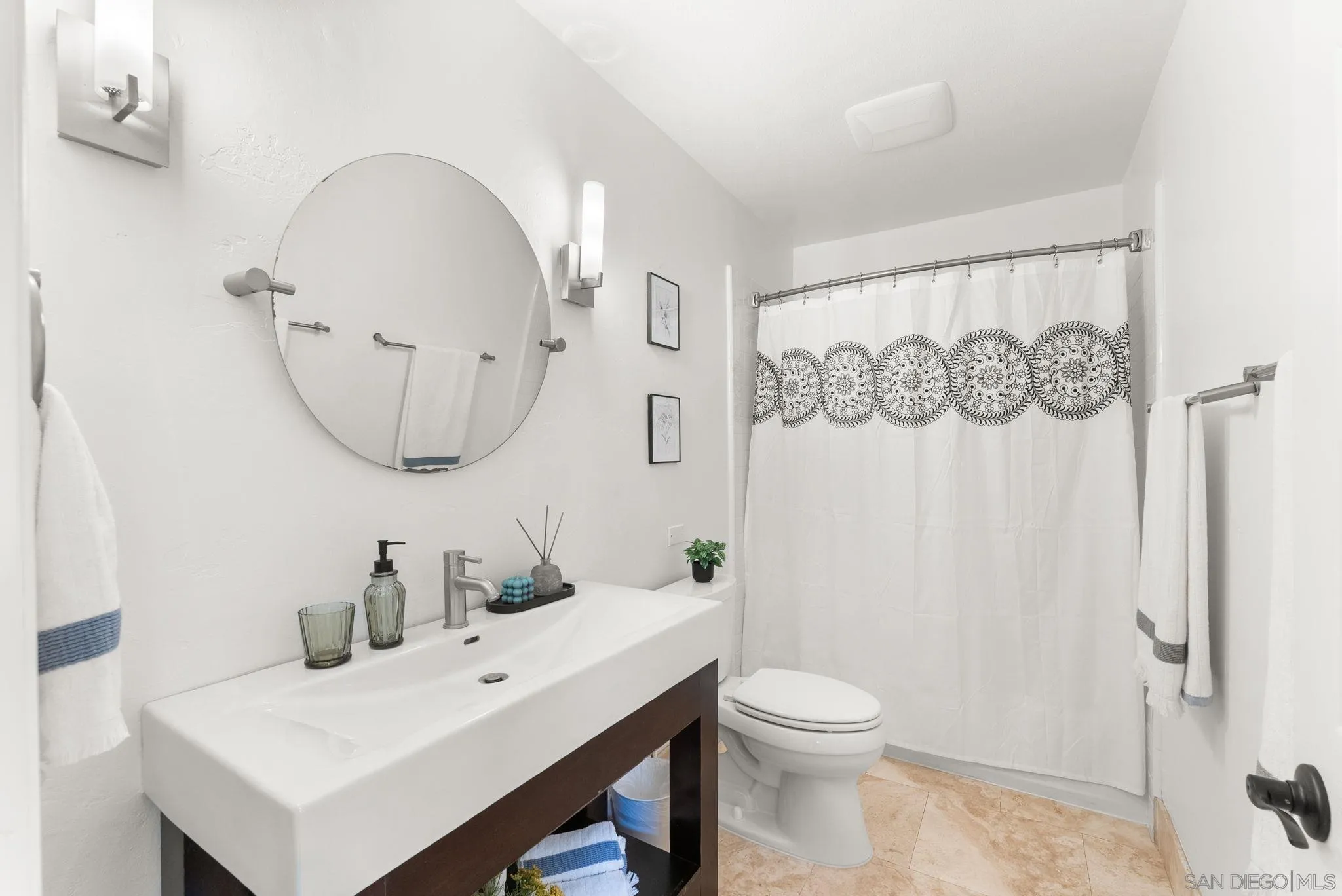12832 Stone Canyon Road Poway, CA 92064 - Photo 31 of 60 a bathroom with a toilet a sink and a mirror