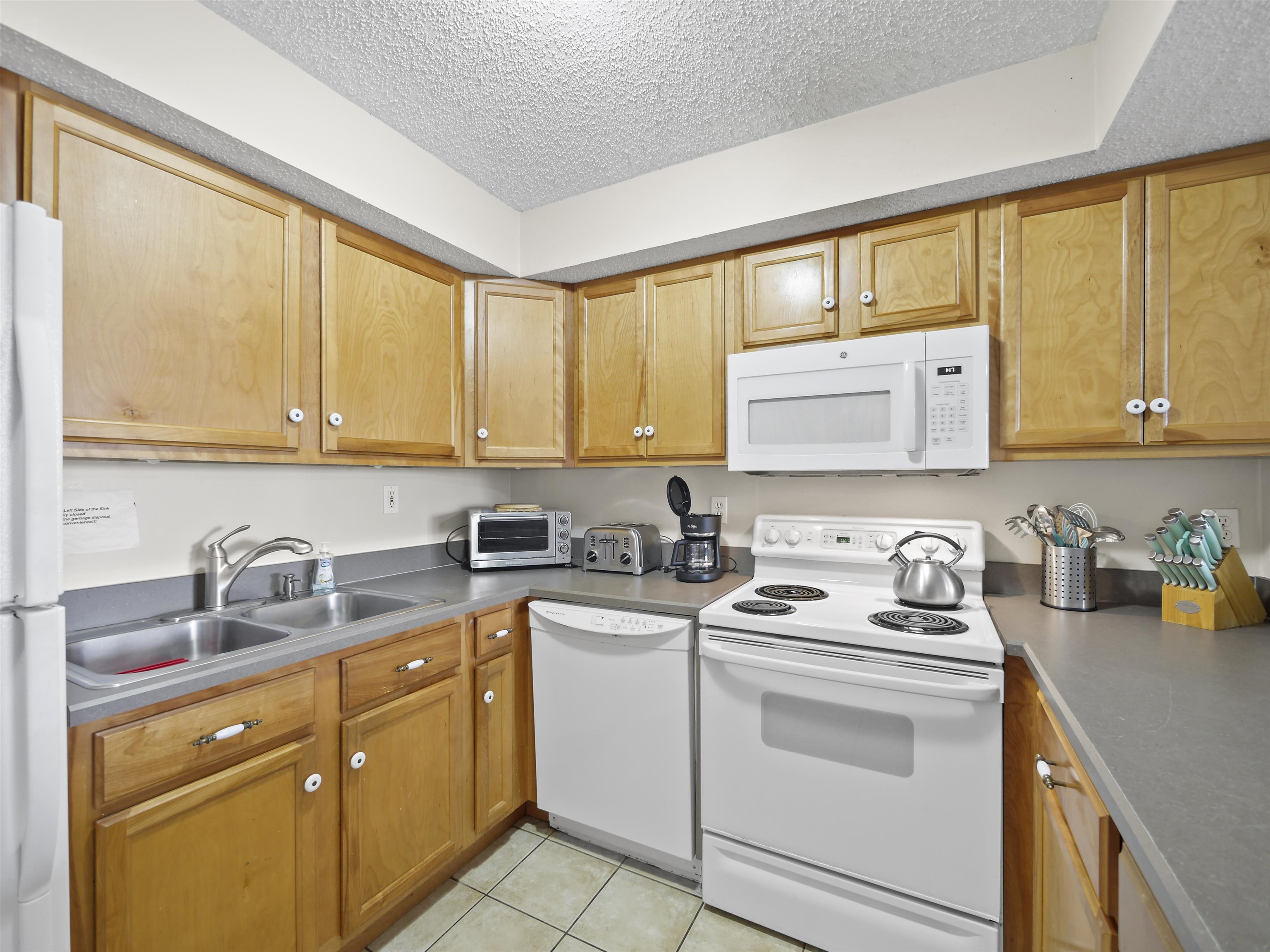 7175 A1A South St. Augustine, FL 32080 - Photo 13 of 35 a kitchen with stainless steel appliances white cabinets sink and a window