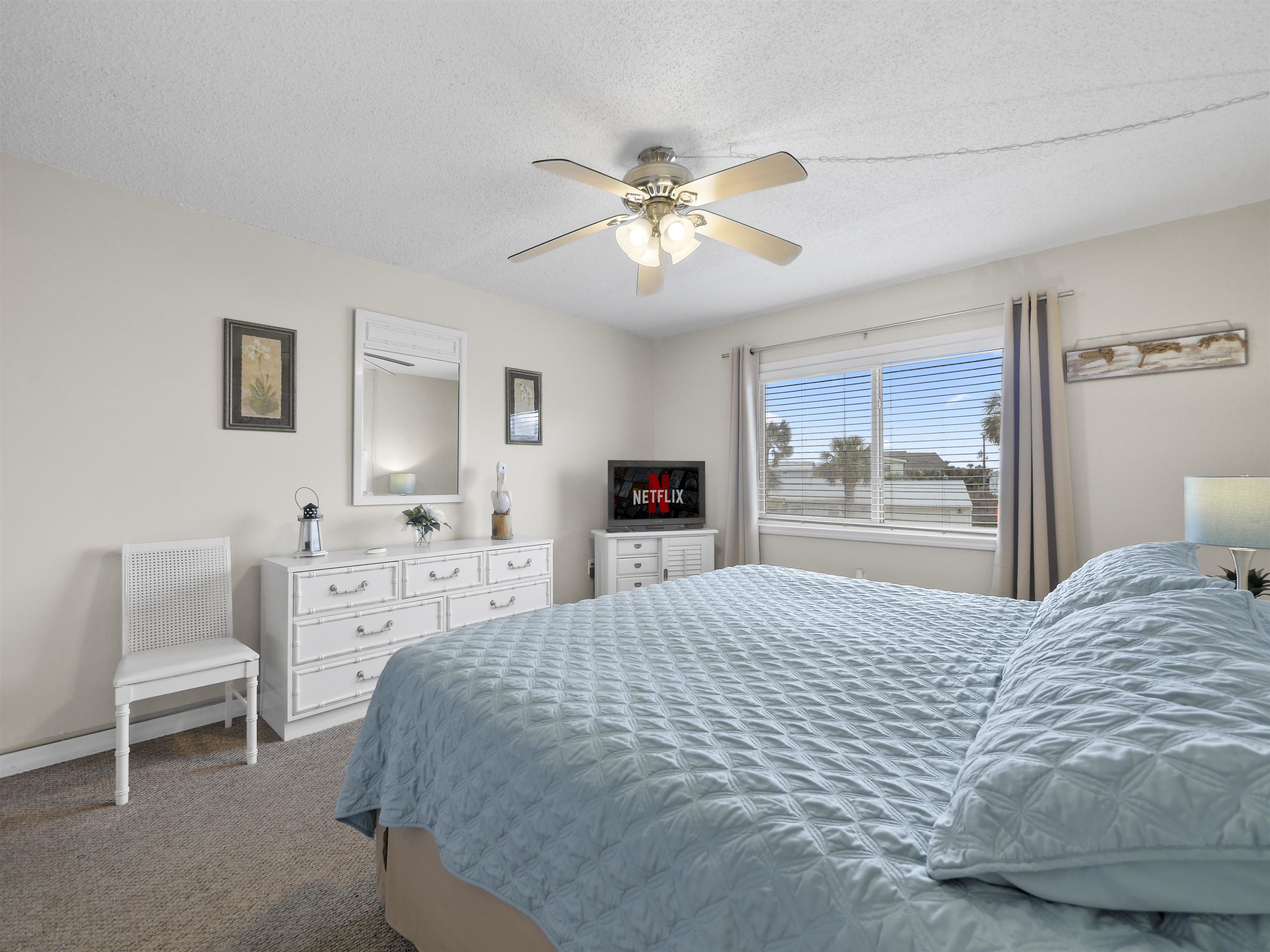 7175 A1A South St. Augustine, FL 32080 - Photo 20 of 35 a bedroom with a large bed and a chandelier