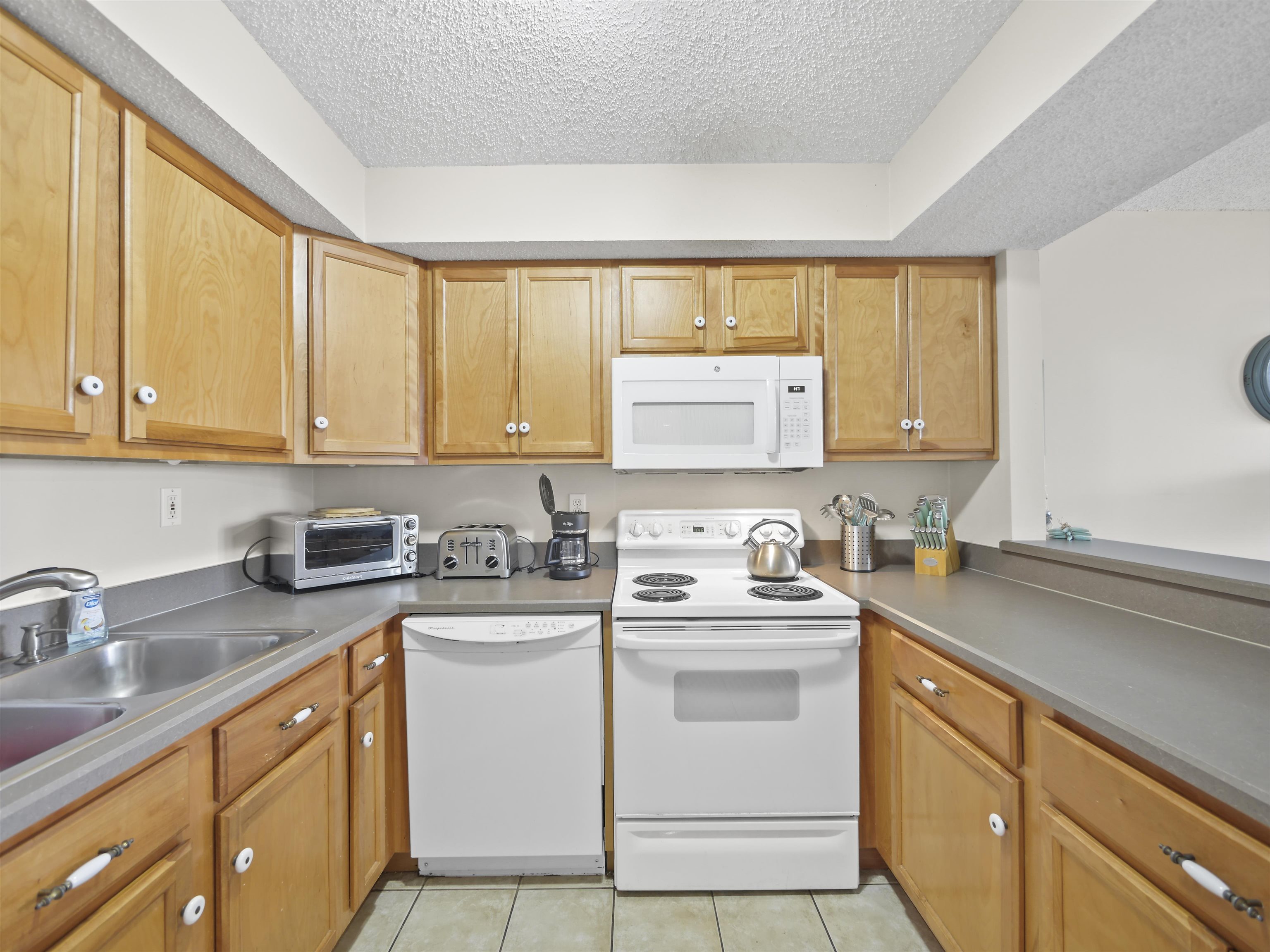 7175 A1A South St. Augustine, FL 32080 - Photo 2 of 35 a kitchen with white cabinets sink and appliances