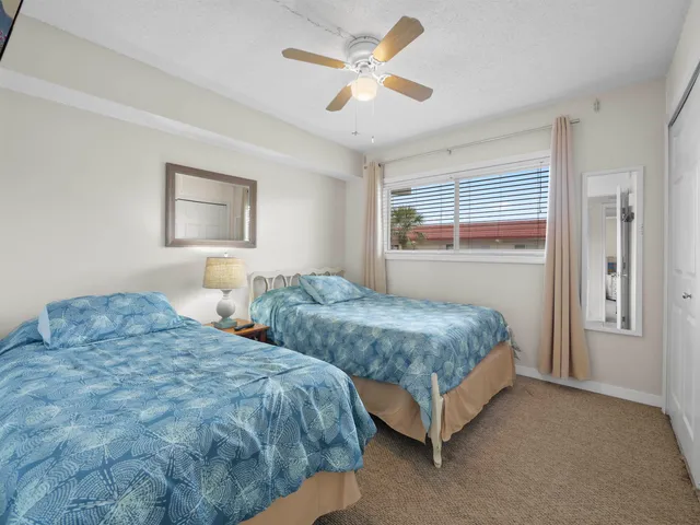 a bedroom with two beds and painting on the wall