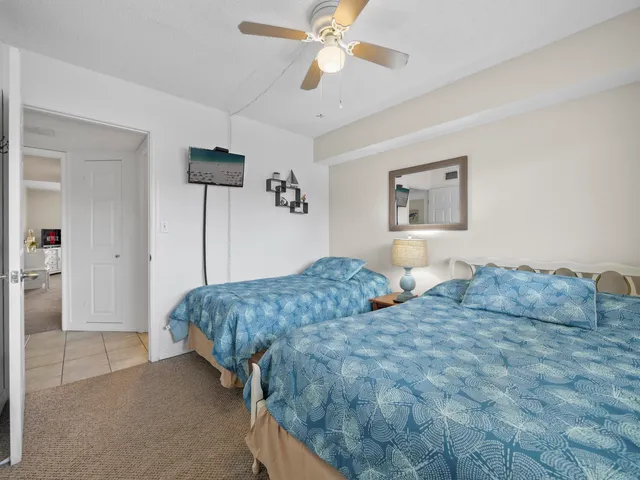 a bedroom with a bed and ceiling fan