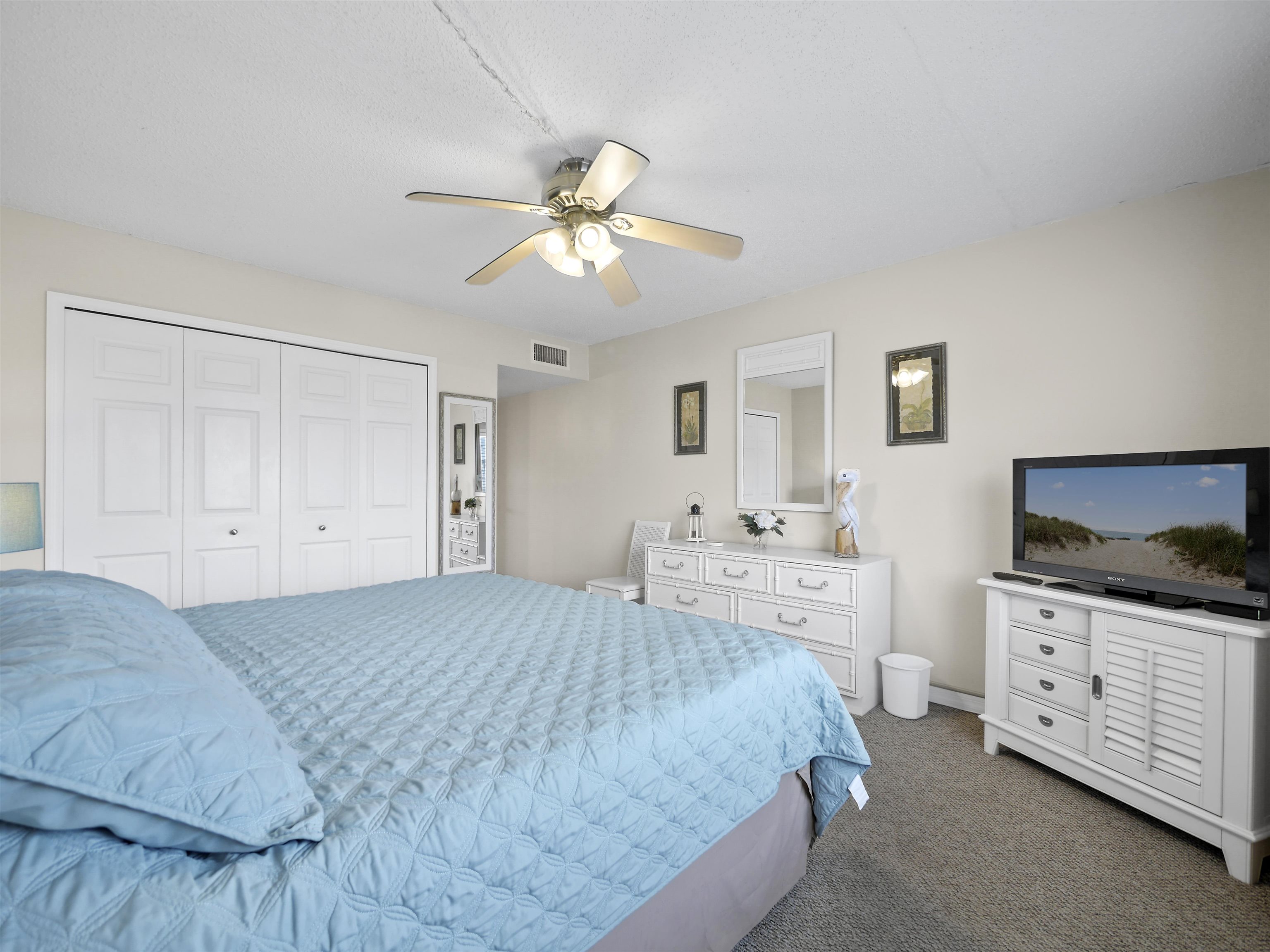 7175 A1A South St. Augustine, FL 32080 - Photo 26 of 35 a spacious bedroom with a bed and a flat screen tv