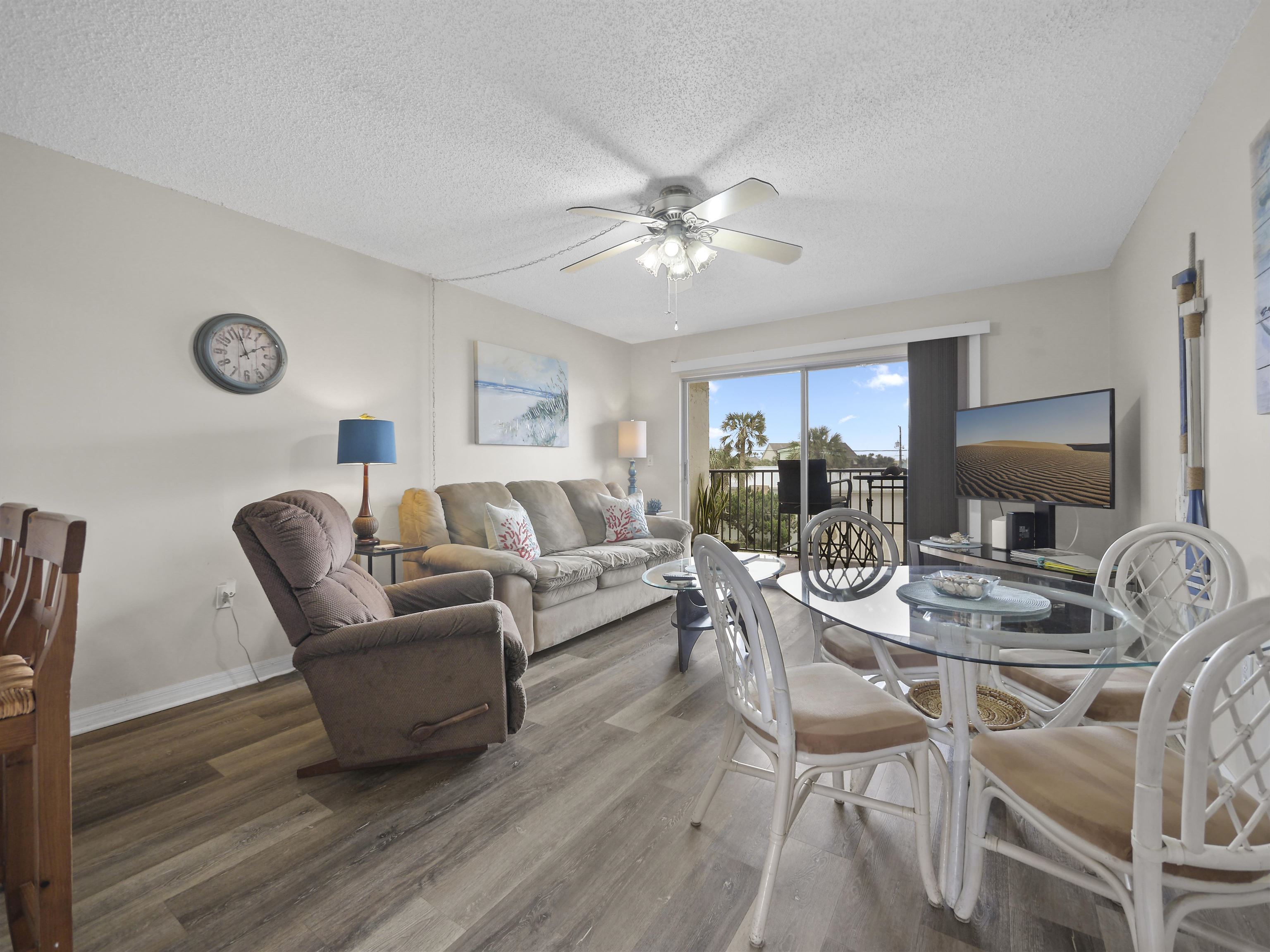 7175 A1A South St. Augustine, FL 32080 - Photo 7 of 35 a living room with furniture a clock on wall and a window