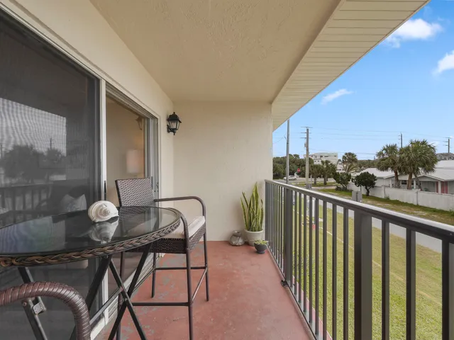 a view of a balcony with chairs