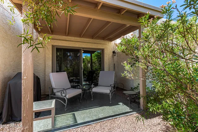 a porch with a table and a chairs