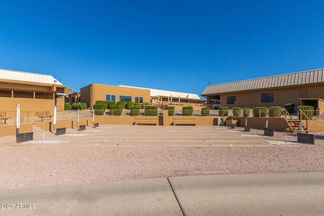 a view of a lake with boats and palm trees