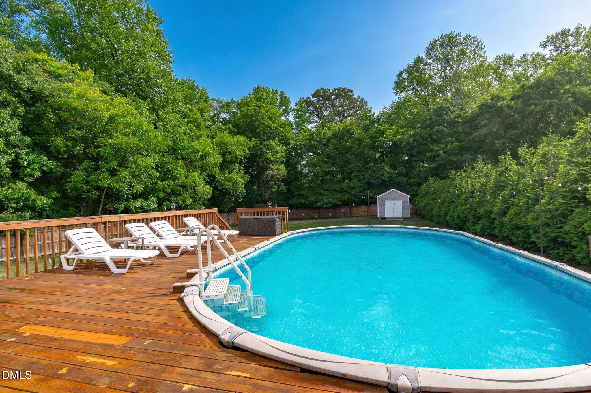 2450 Rolling Tracks Road Willow Spring, NC 27592 - Photo 5 of 64 a view of a swimming pool with a patio