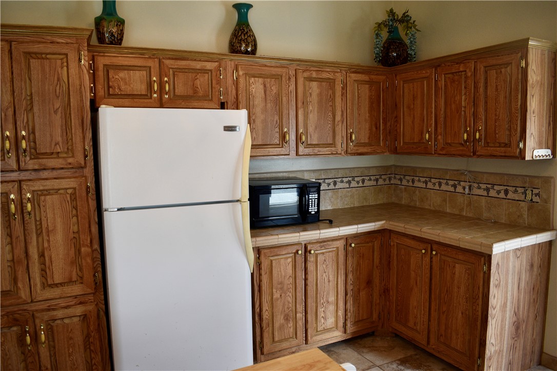 25051 Lake Shore Drive Mathis, TX 78368 - Photo 11 of 40 a kitchen with stainless steel appliances granite countertop a refrigerator a stove a sink and dishwasher
