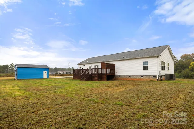 a view of a house with pool and chairs