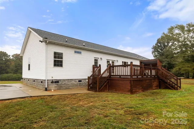 a view of a house with a yard and sitting area