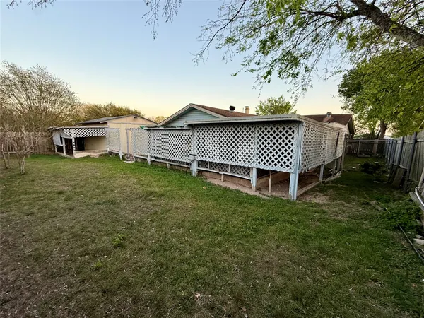 a backyard of a house with a table and chairs