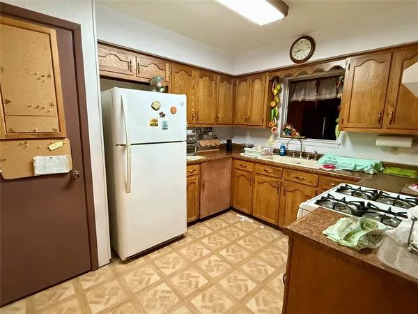 a kitchen with a refrigerator and a sink