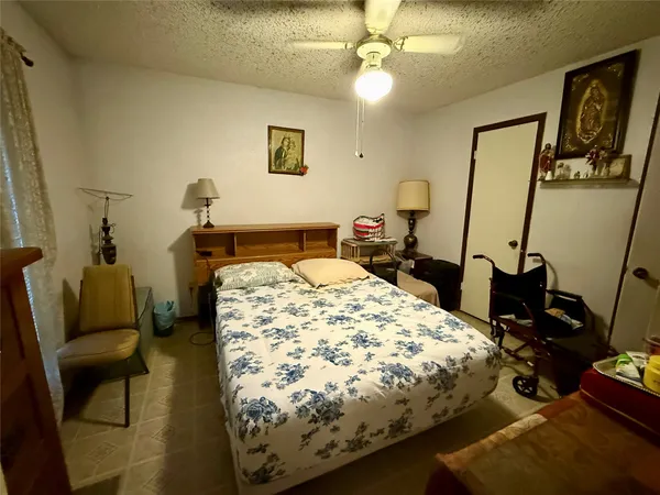 a bedroom with a bed and a mirror