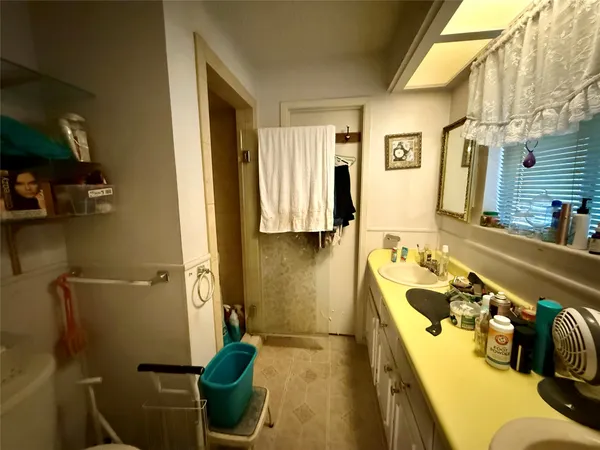 a bathroom with a sink a toilet and tub