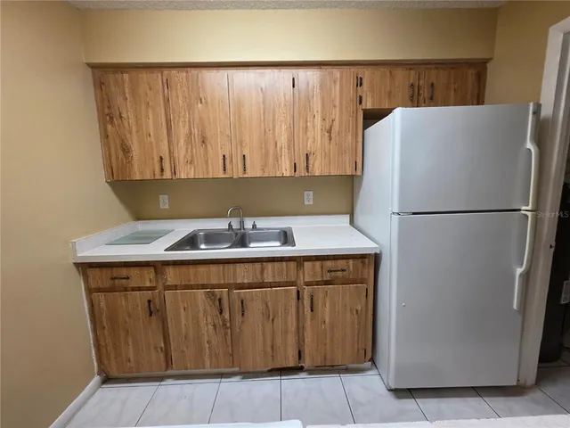 a kitchen with a refrigerator and a stove