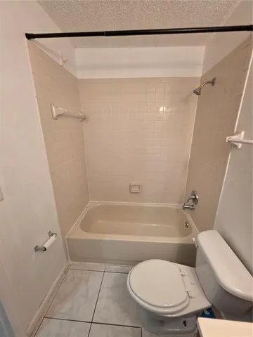 a bathroom with a toilet and a bath tub