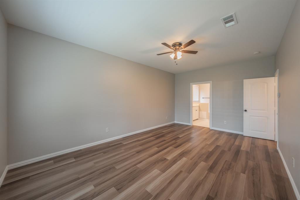 412 Hideaway Road McKinney, TX 75072 - Photo 19 of 40 a view of empty room with wooden floor and fan