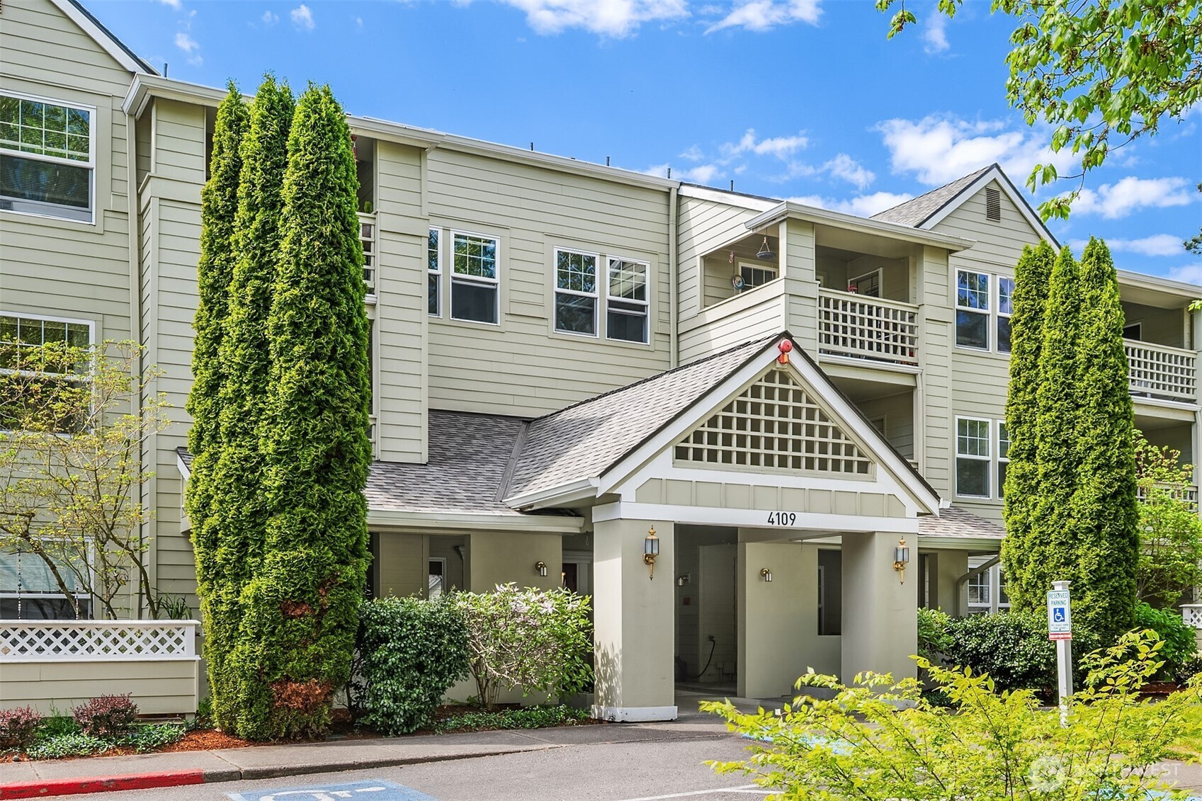 4109 224th Lane Southeast, Unit 213 Issaquah, WA 98029 - Photo 1 of 34 a front view of a house with a yard and potted plants