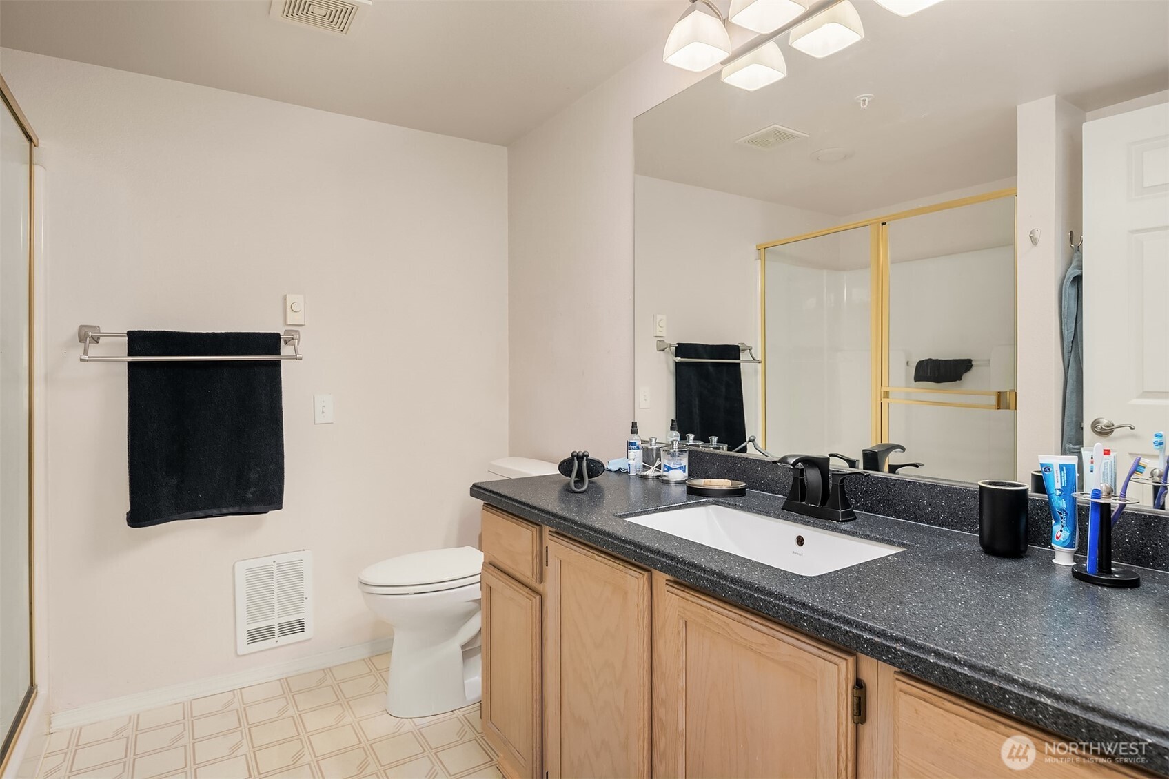 4109 224th Lane Southeast, Unit 213 Issaquah, WA 98029 - Photo 11 of 34 a bathroom with a sink double vanity granite and a toilet